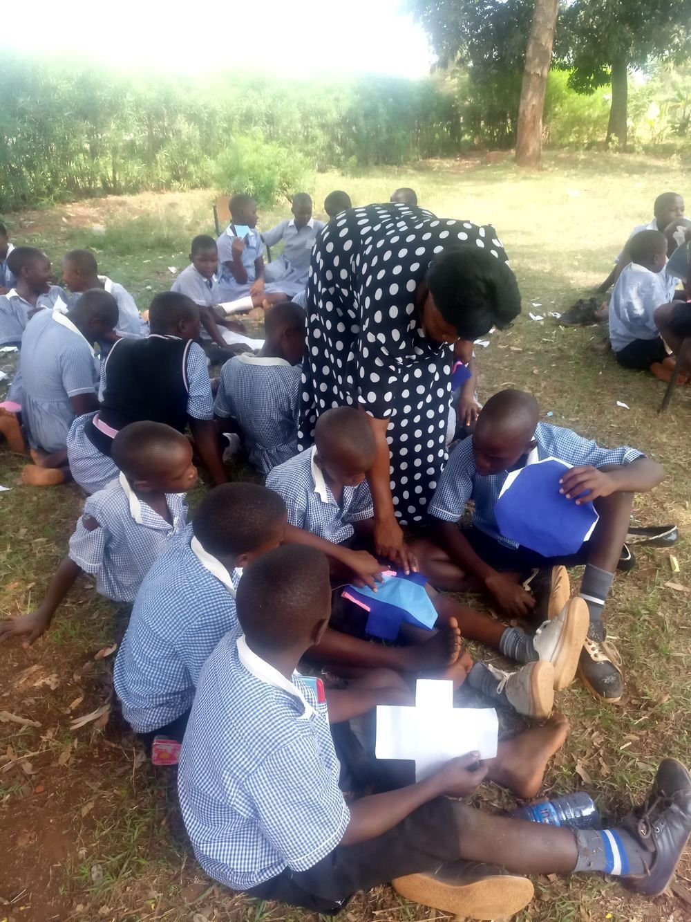 A counsellor working with pupils on the ground